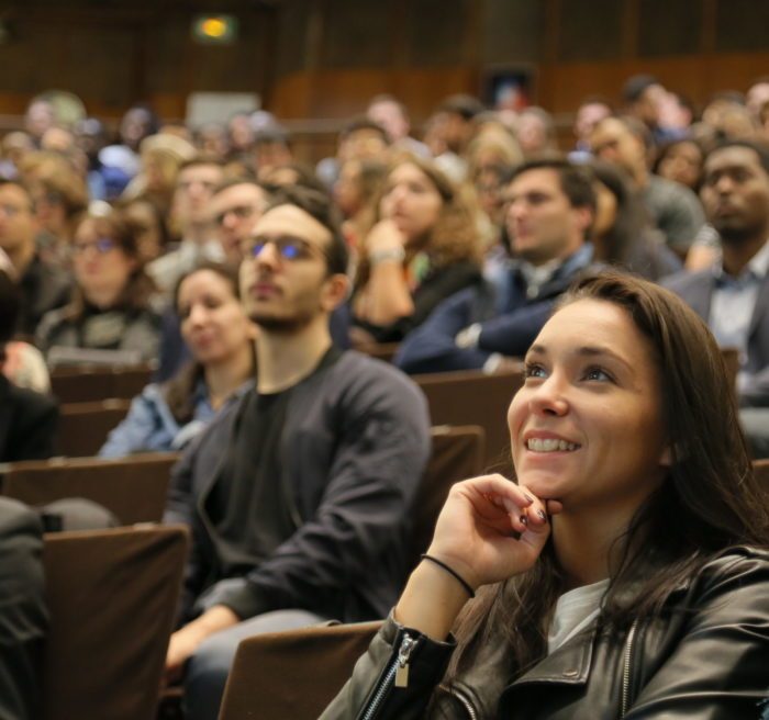 Student listening to a lecture in a lecture hall