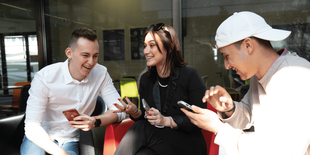 Students of the INSEEC Bachelor business school talking with their phones in hand