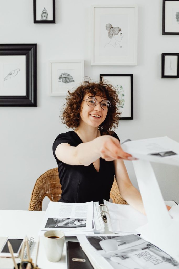 smiling student who gives back her project  