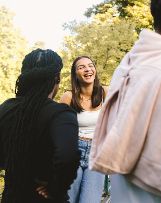 Student laughing with a group of students from the INSEEC business school