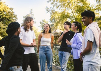 Group of students from the INSEEC business school chatting and laughing in a park in Bordeaux