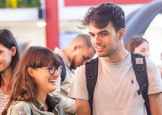 Students from the INSEEC business school talking and laughing at an event on the Chambéry campus