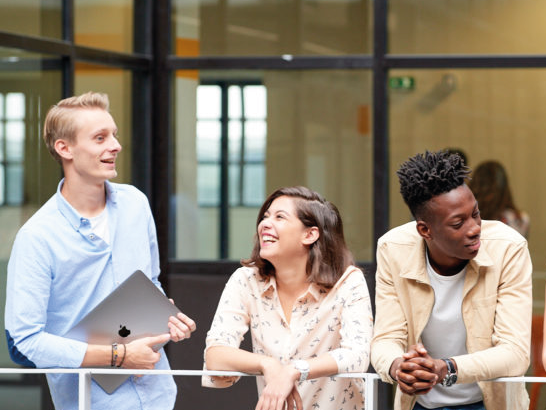 Students on the Lyon campus talking and laughing in the corridors during the finance inter-course