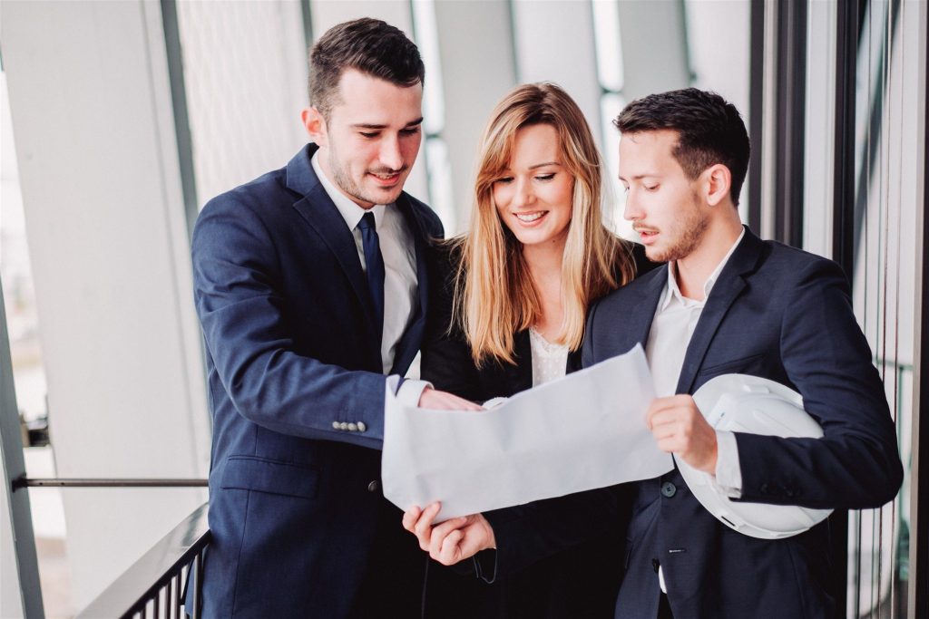 3 young graduates discussing business together
