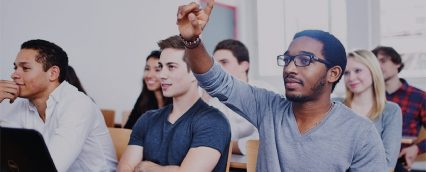 Student raises hand in purchasing and supply chain class