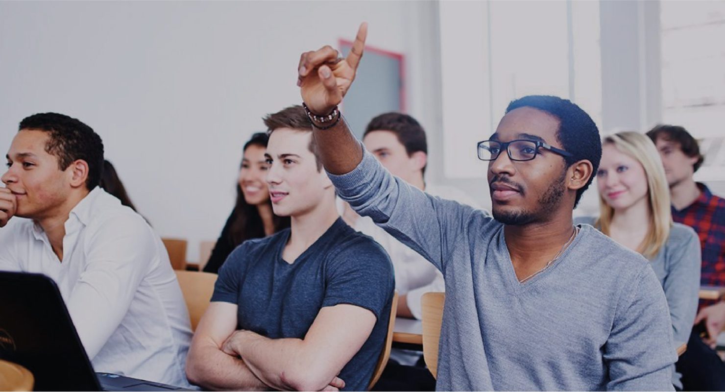 Student raises hand in purchasing and supply chain class