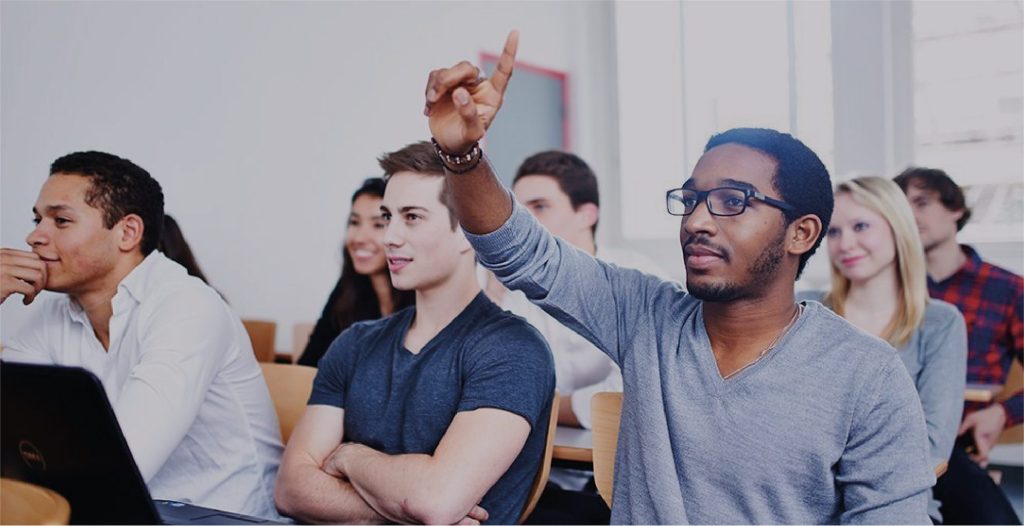Student raises hand in purchasing and supply chain class