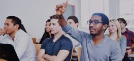 Student raises hand in purchasing and supply chain class