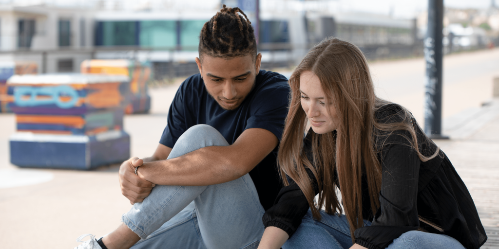 two students from the INSEEC Bachelor business school working on a computer and installed on the docks