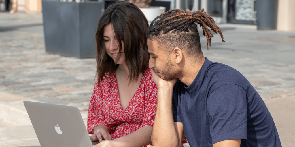 students from the INSEEC business school set up outside to work around a computer