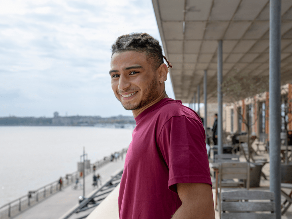 student of the INSEEC business school outside on a terrace smiling