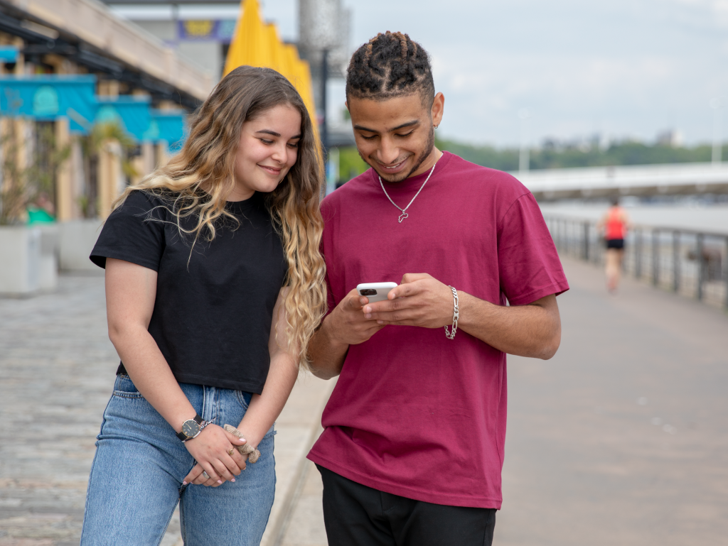 two students from the INSEEC business school outside on their mobile phones