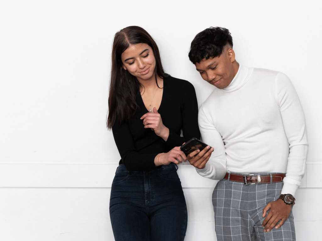 two students from the INSEEC business school looking at a mobile phone screen