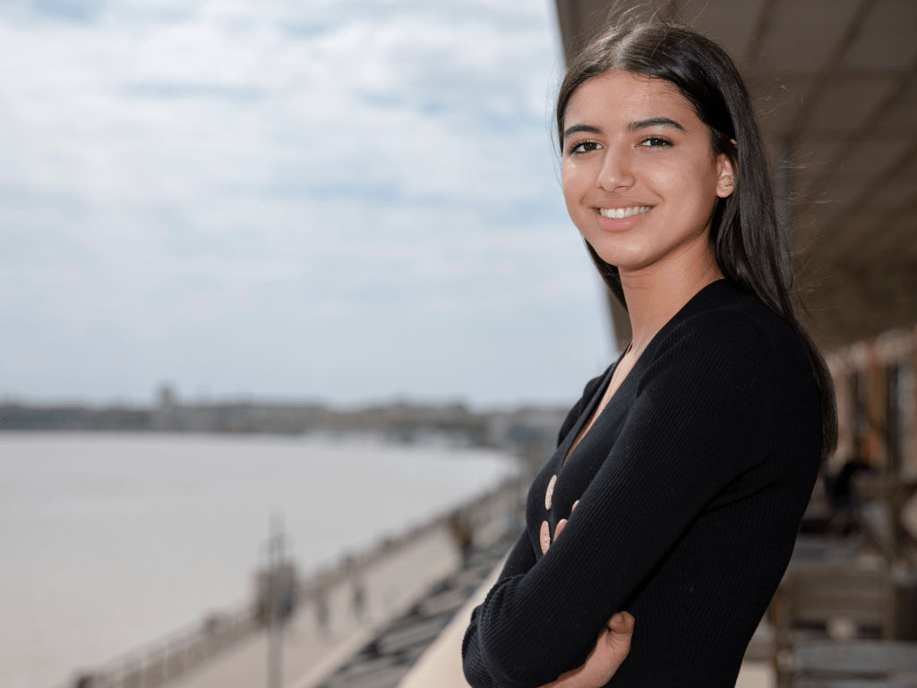 student of the INSEEC business school outside on a terrace and smiling