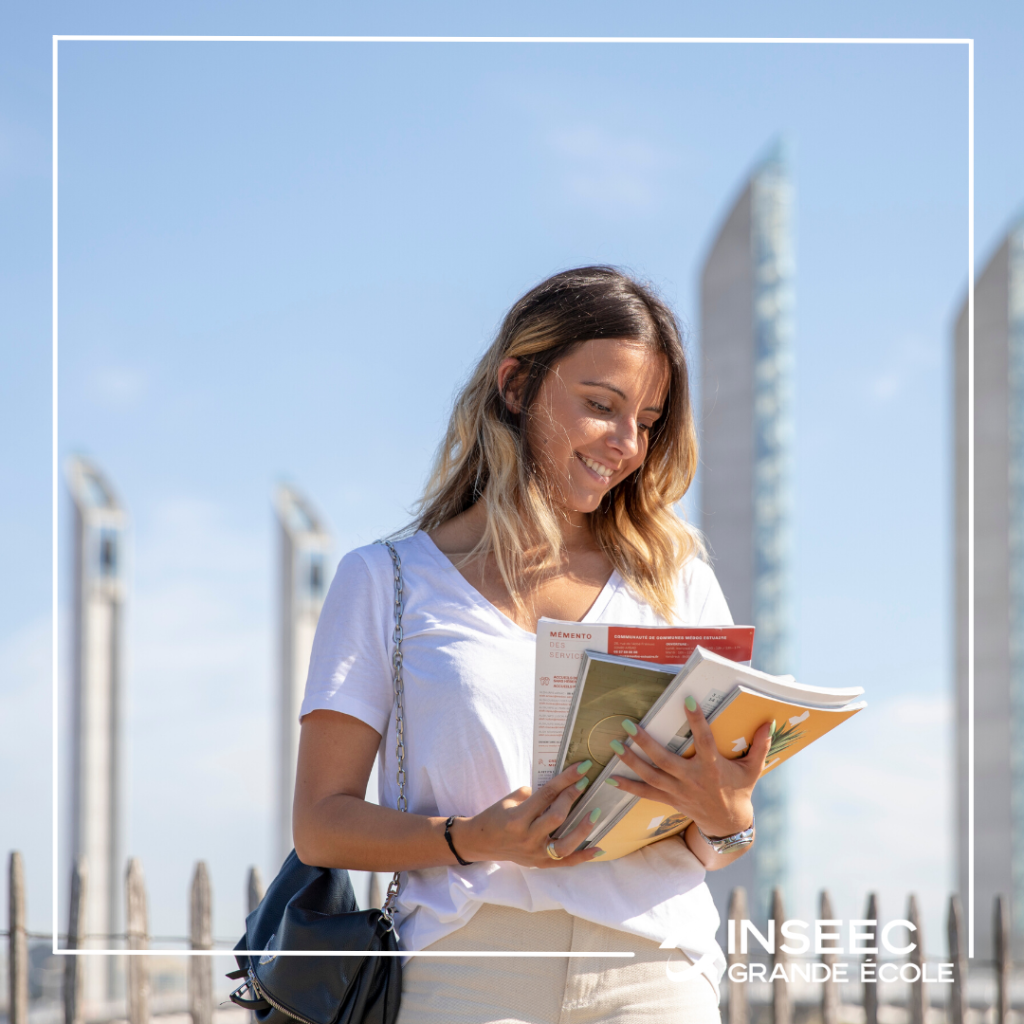 future student reading an inseec grande ecole admissions brochure