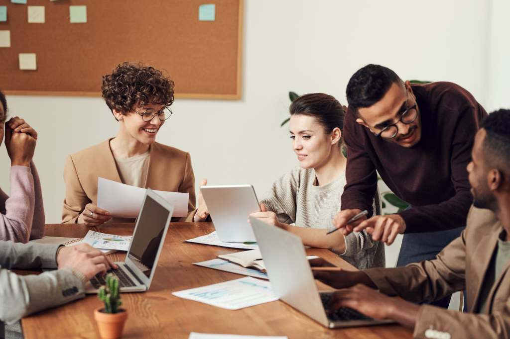 people gathered around a table for a meeting